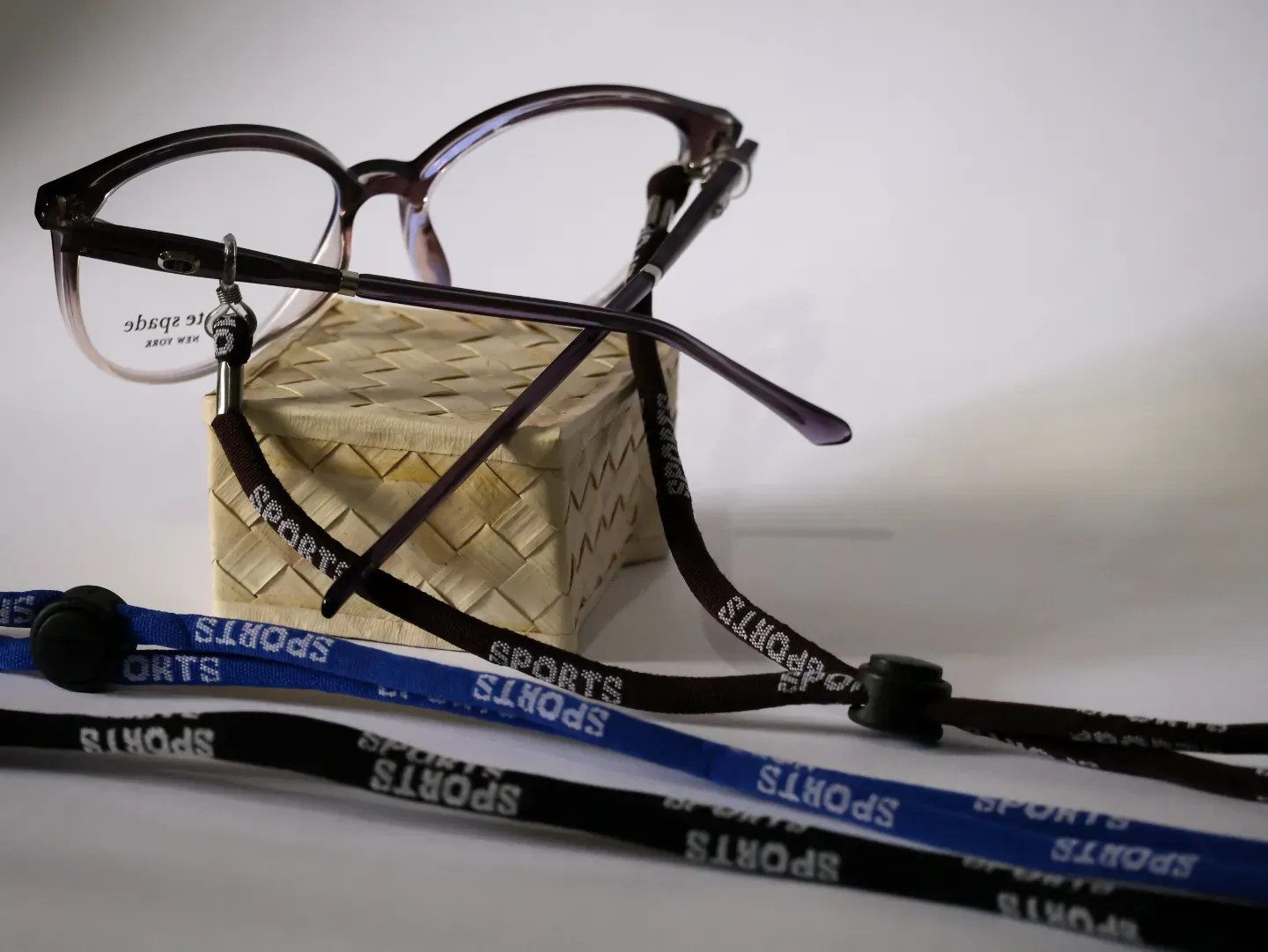 Adjustable sports cord tightly securing athletic eyewear.