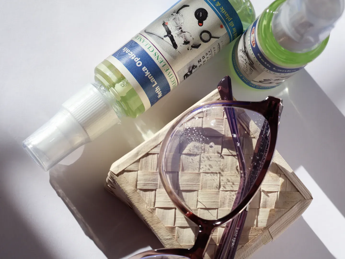 Bottle of anti-reflective lens cleaner spray for optical lenses.