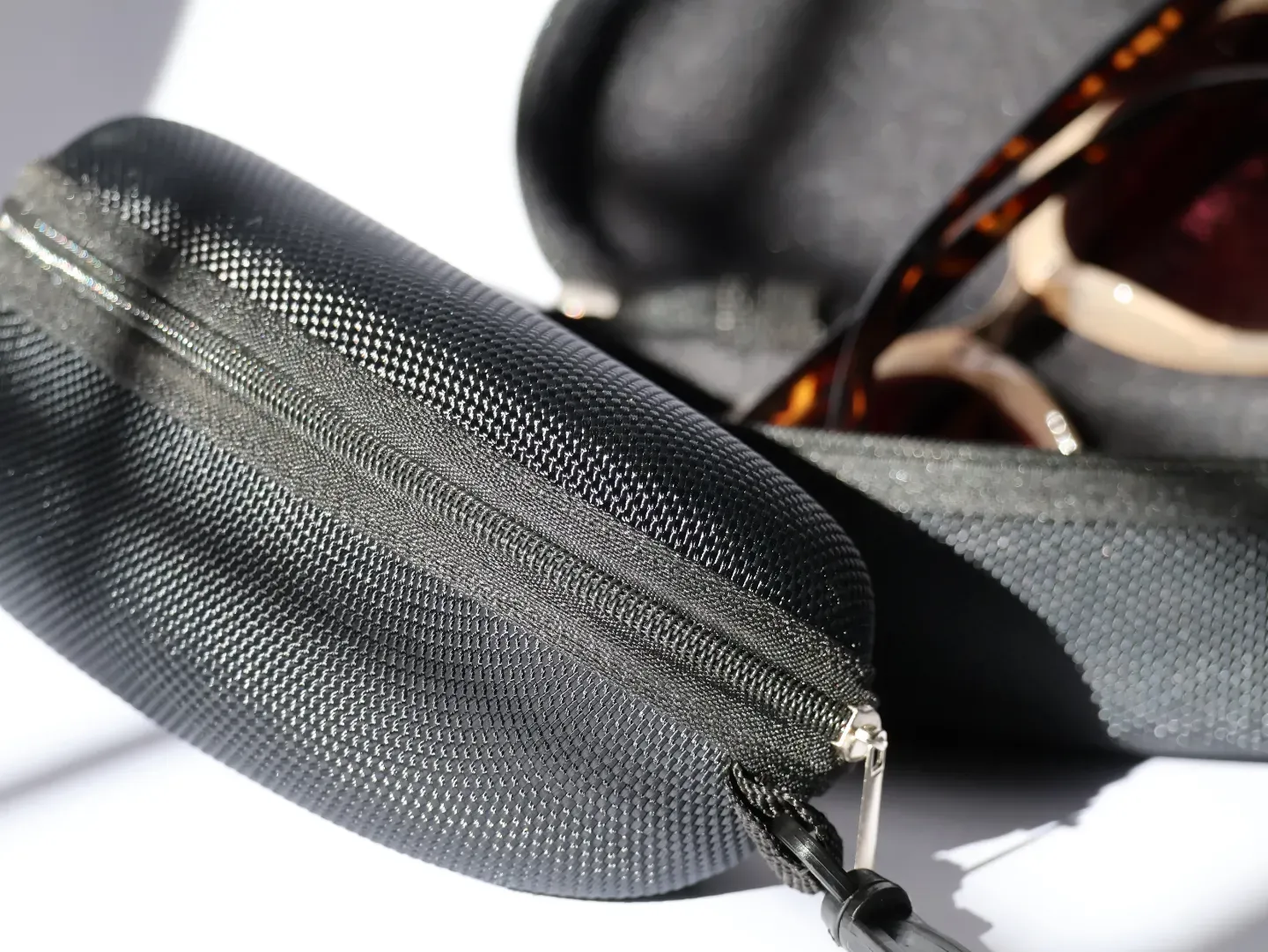 Crush-proof hard shell case for eyeglasses and sunglasses.