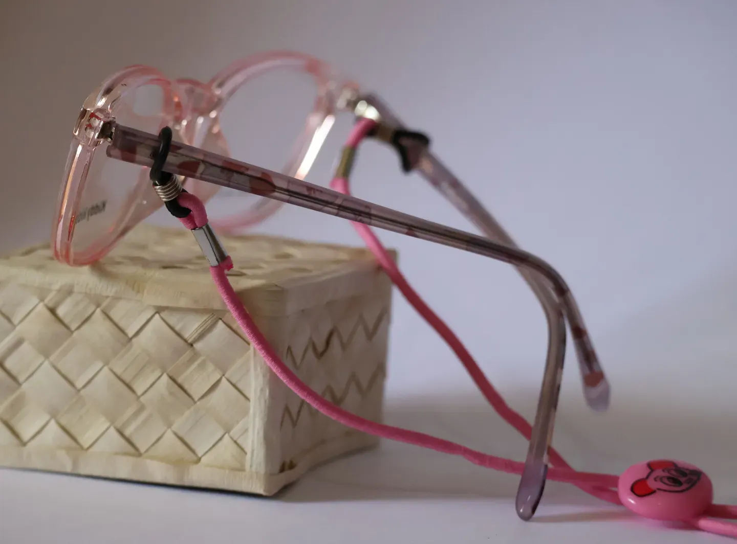 Colorful kids eyeglass cord attached to children's prescription frames.