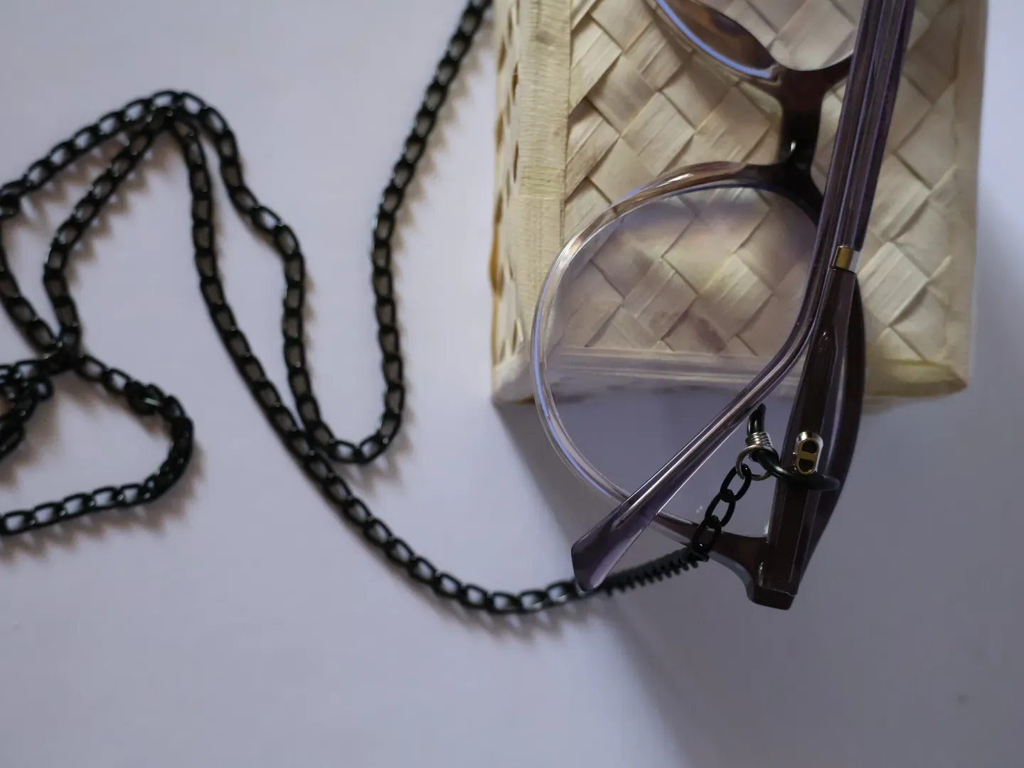 Woman wearing specs secured with a stylish metal neck strap from Neth Lanka Opticals.