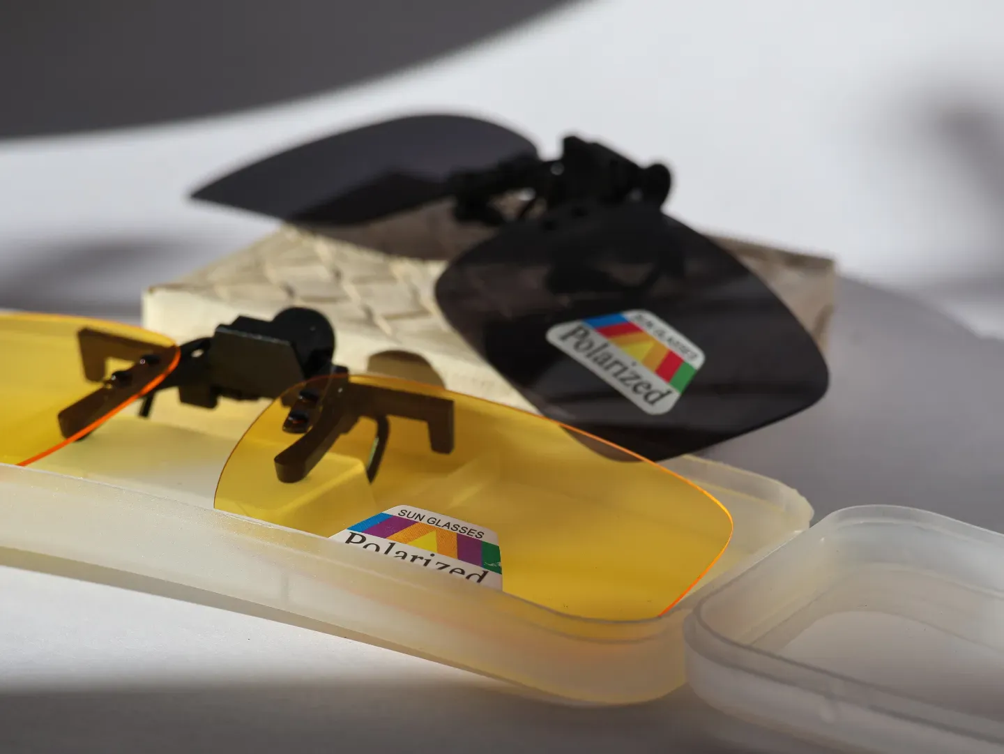 Yellow tinted clip-on lenses designed for anti-glare night driving.