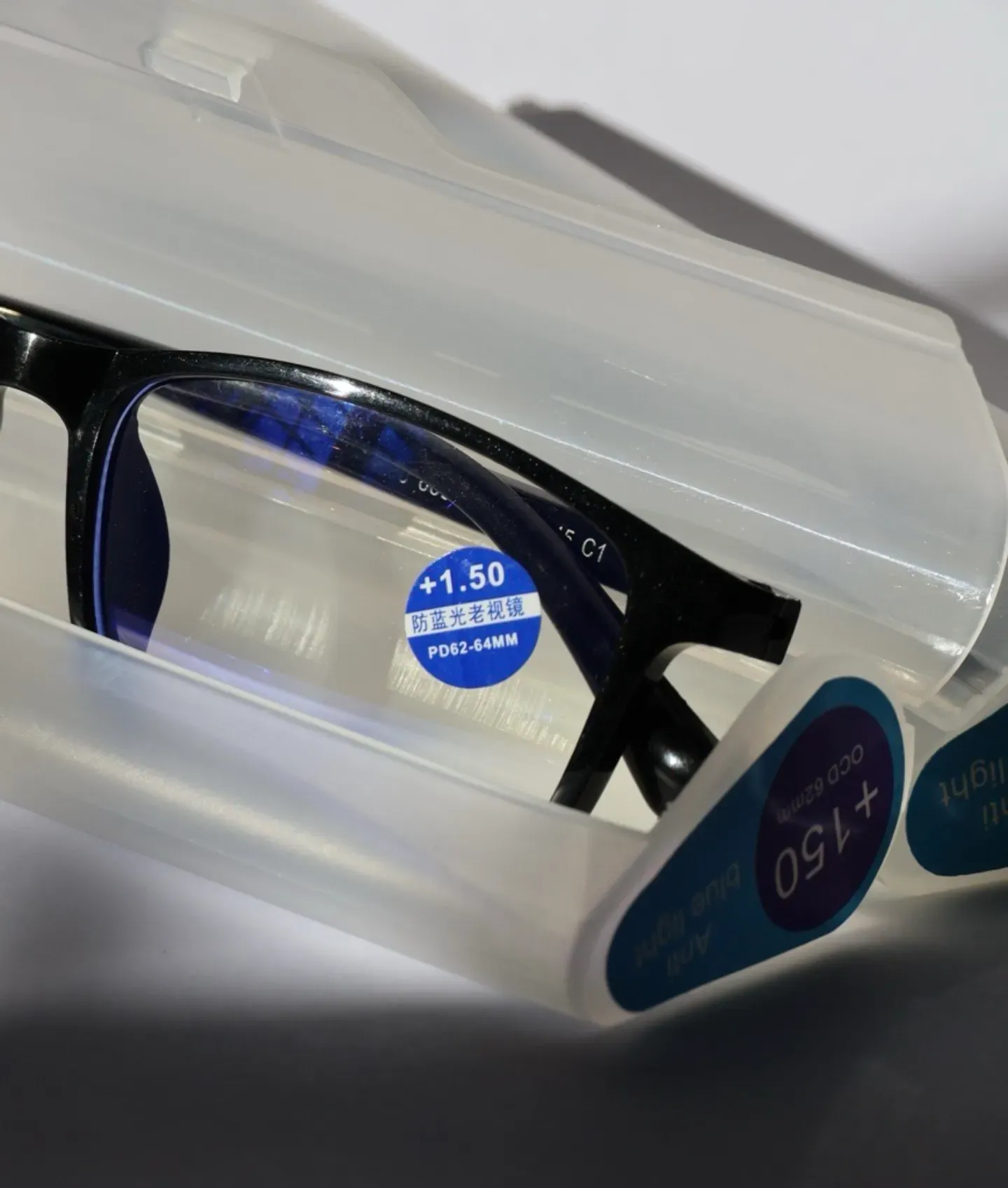 Close up of reading glasses lenses with +2.00 magnification power.