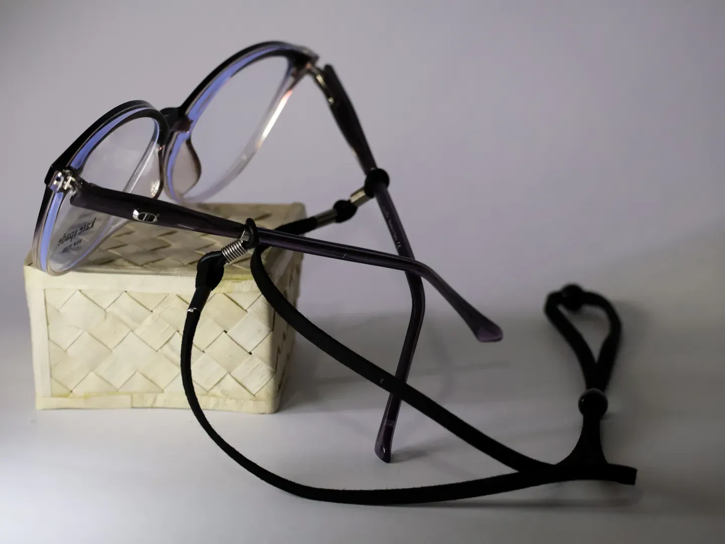 Stylish woven lanyard-style eyeglass cord with vibrant patterns.